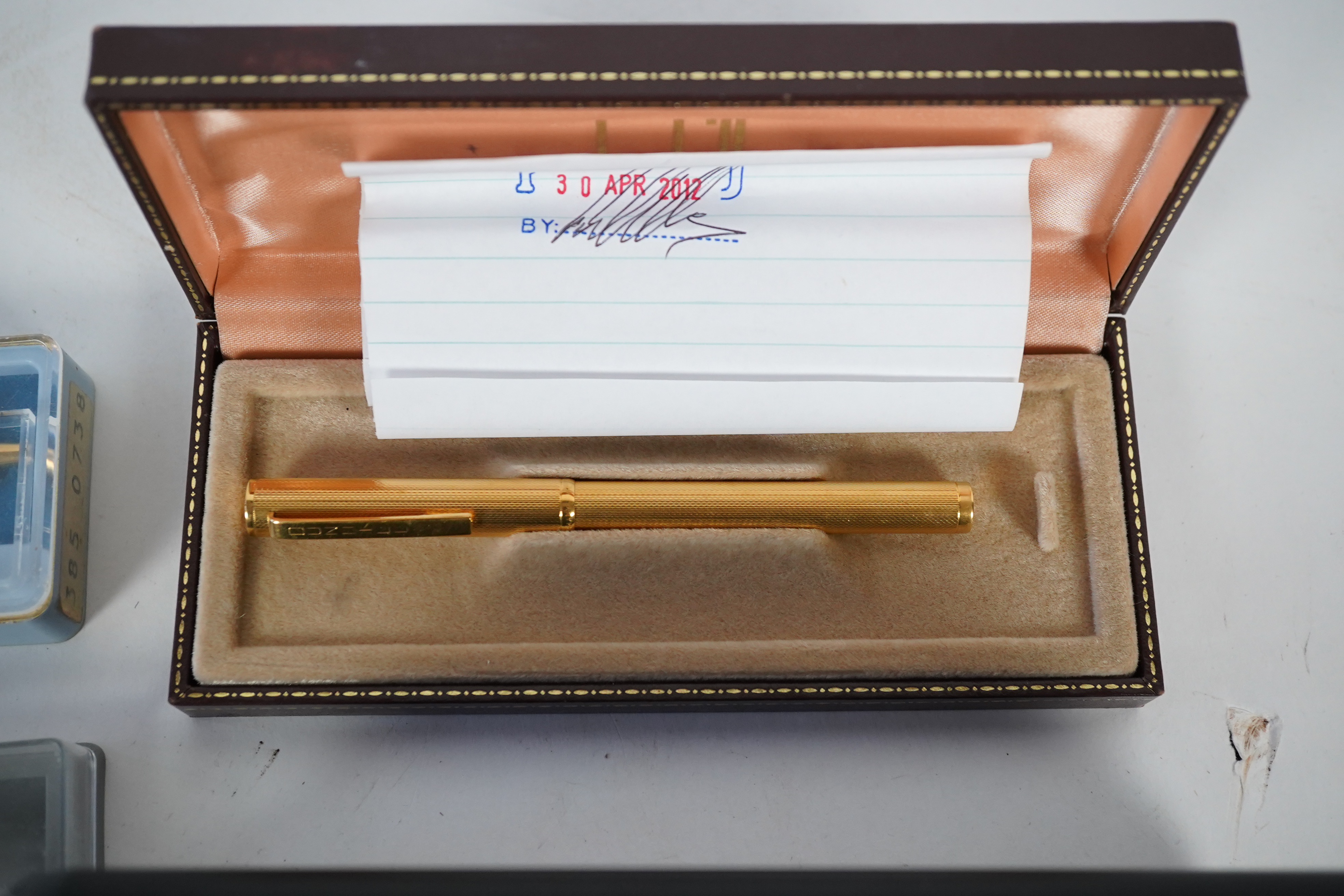 A cased Parker duofold ballpoint pen, a cased Parker Sonnet lacquer ruby red fountain pen, a Dunhill gold plated fountain pen and various fountain pens and ballpoint pens including Parker, Sheaffer, Quill, etc.